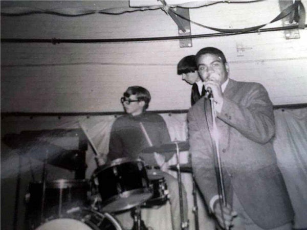 Setting up before a Younger Generation performance at Oyster Bay High School gymnasium. Left to right, Bob Levitan (at drums), Alan Galasso, Joe Tolliver at microphone (roadie) 